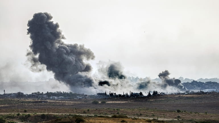 Smoke rises following an Israeli airstrike in the Gaza Strip,...