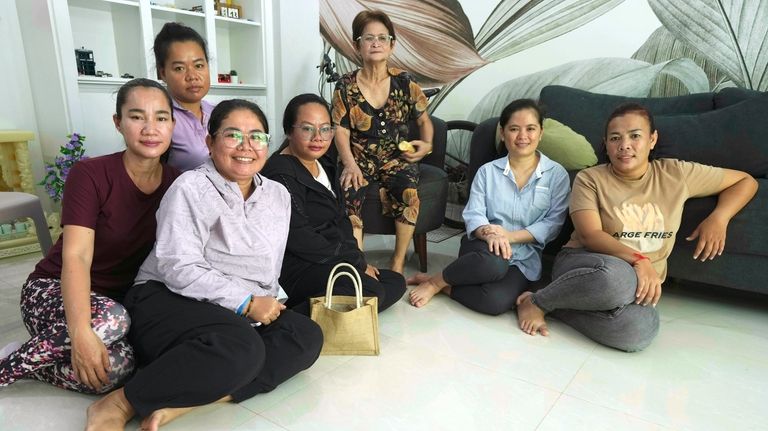 Chhim Sithar, second from right, president of the Labor Rights...