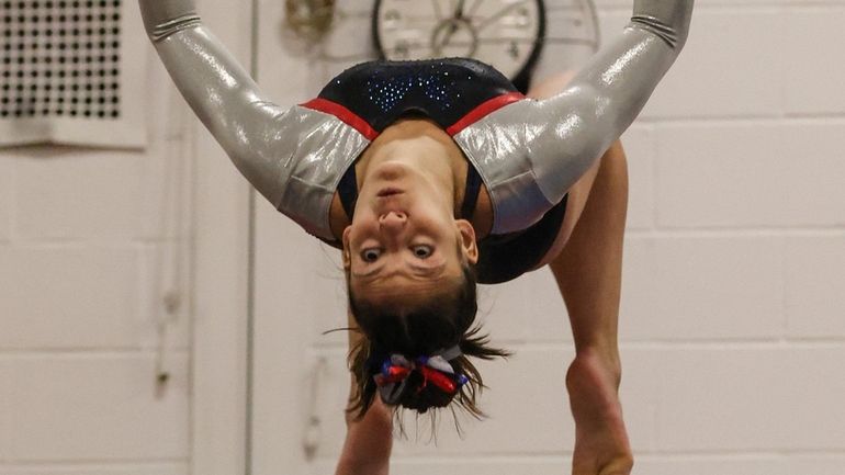 Hannah Hughes of Middle Country competes in the balance beam...