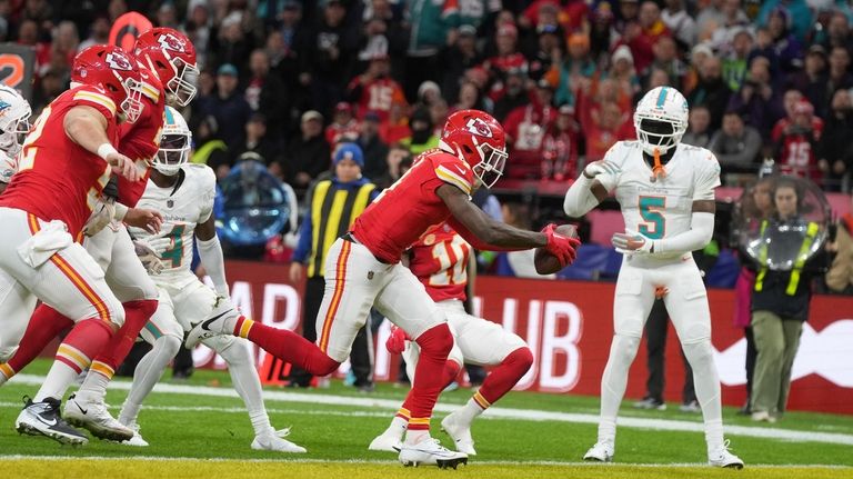 Kansas City Chiefs wide receiver Rashee Rice scores past Miami...