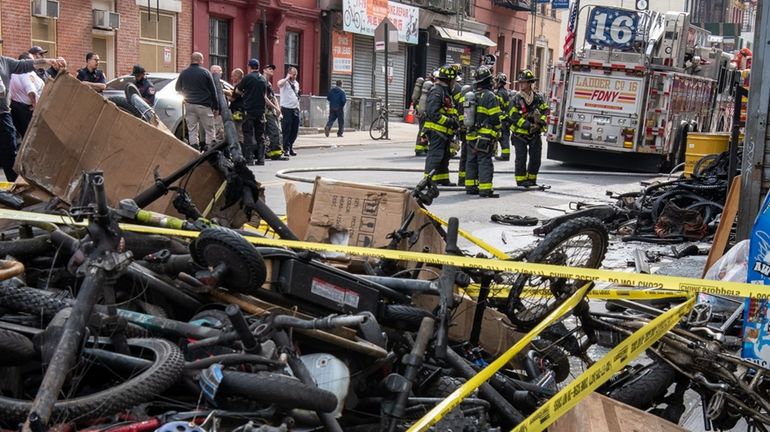 Firefighters at the scene of a fire caused by exploding...