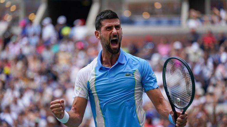 Novak Djokovic, of Serbia, reacts after defeating Taylor Fritz, of...