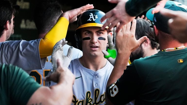 Oakland Athletics' Tyler Soderstrom celebrates with teammates after hitting a...