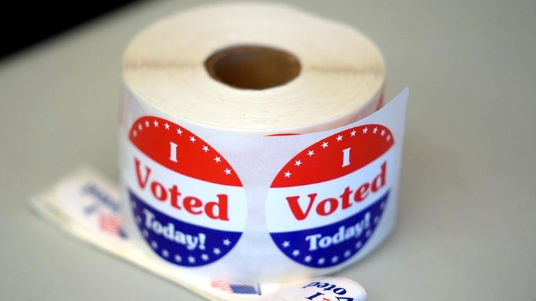 A spool of stickers rests on a table at a...