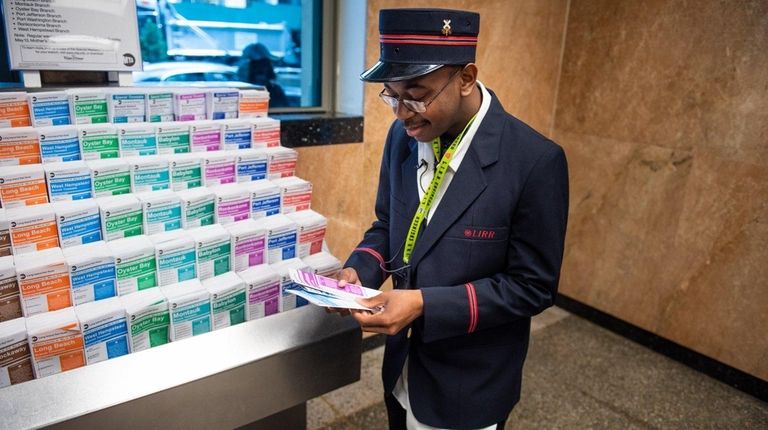 Malik Ellis looks over schedules at the LIRR Jamaica station...