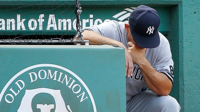 New York Yankees manager Joe Girardi looks down during the...