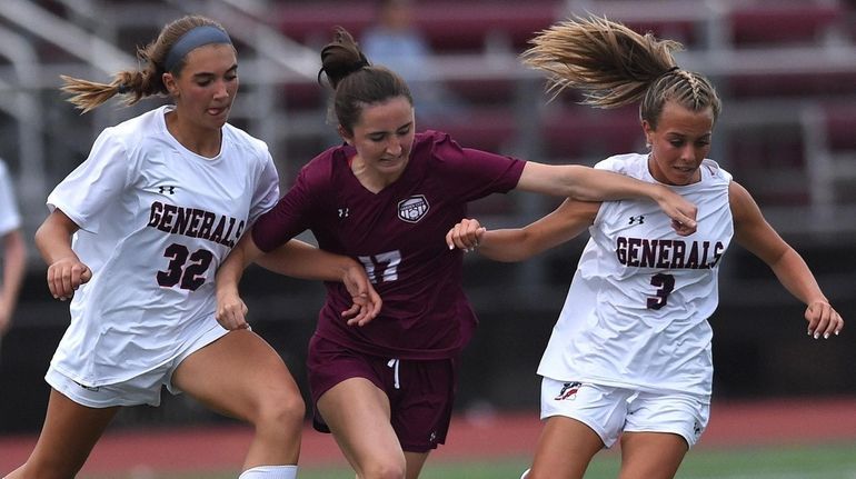 Catherine Hayes of Garden City, center, tries to squeeze past MacArthur...