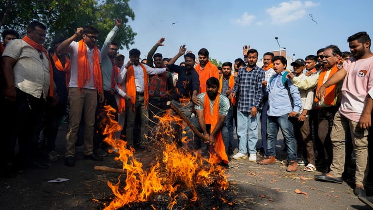 Activists of right-wing Hindu groups reacting to Sunday’s suspected militant...