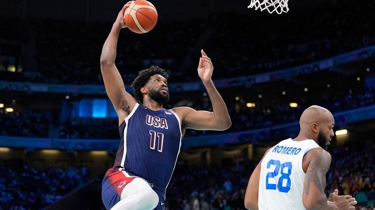 United States' Joel Embiid, left, goes up for a dunk...