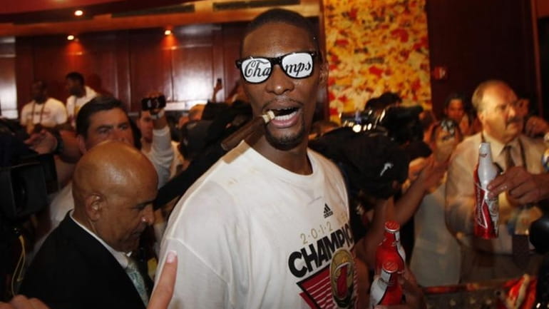 The Miami Heat's Chris Bosh celebrates in the locker room...