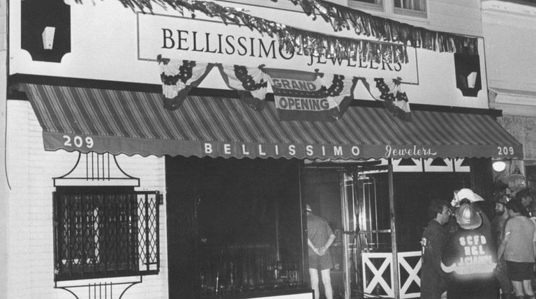 Firemen stand in front of Bellissimo Jewelers on Glen Cove...