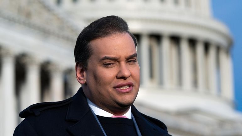 Rep. George Santos faces reporters at the Capitol in Washington.