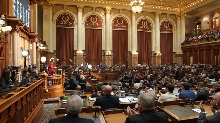 Gov. Kim Reynolds, standing left, gives the annual Condition of...