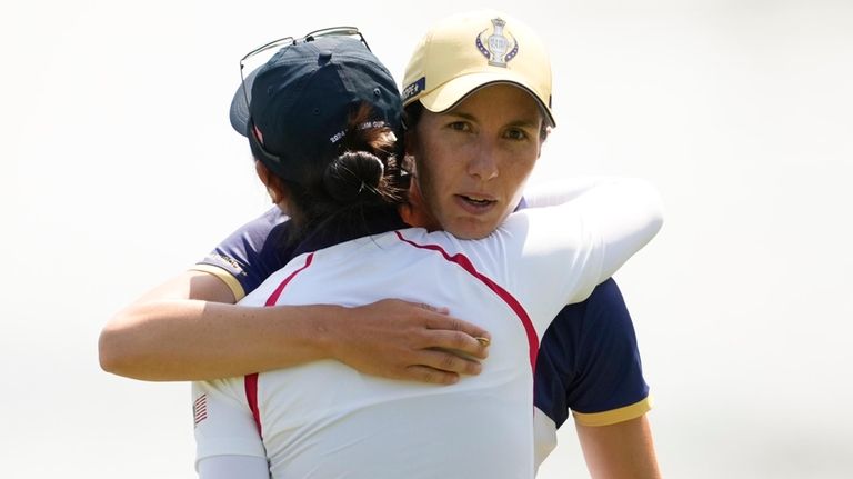 Europe's Carlota Ciganda, right, concedes to United States' Rose Zhang...