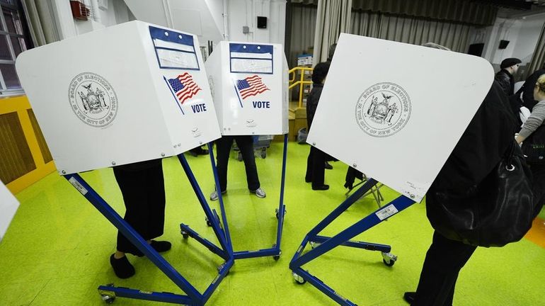 Residents cast their ballots to vote in the 2012 General...