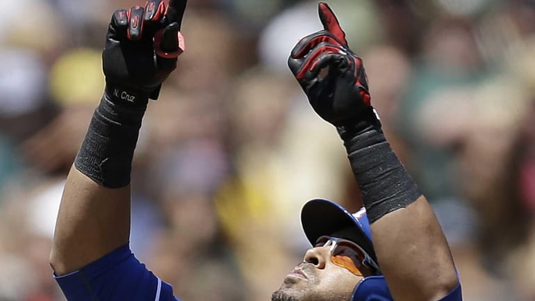 Texas Rangers outfielder Nelson Cruz celebrates after hitting a home...