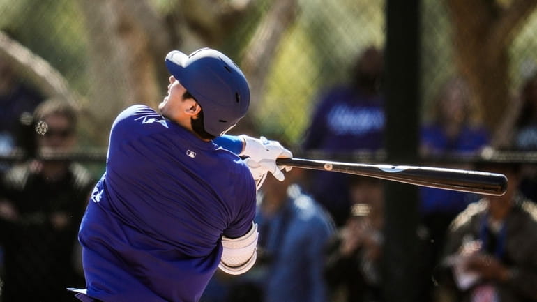 Los Angeles Dodgers designated hitter Shohei Ohtani participates in spring...
