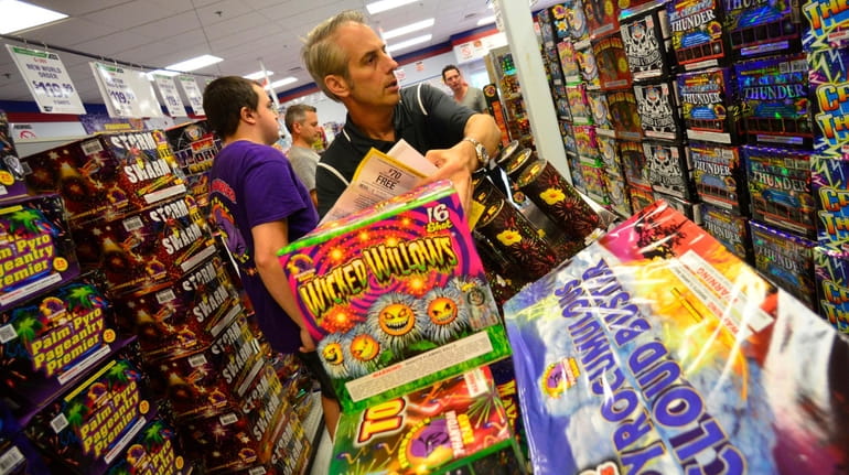 Craig Allen of New York fills up his shopping cart with fireworks...