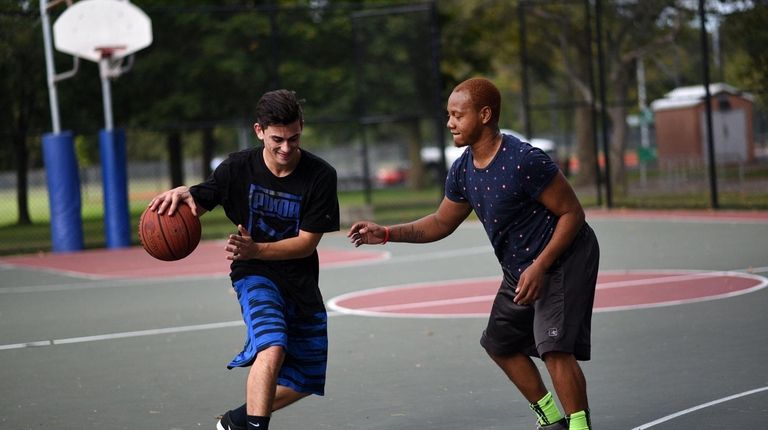 People play a game of basketball at Cantiague Park in Hicksville.