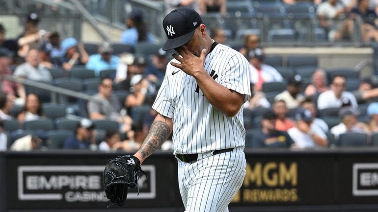 Yankees starting pitcher Nestor Cortes walks to the dugout after...