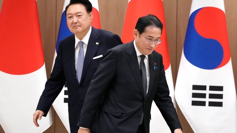 South Korean President Yoon Suk Yeol, left, and Japanese Prime...