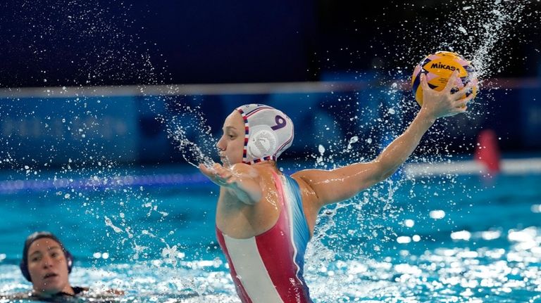 France's Ema Vernoux scores a goal during a women's water...