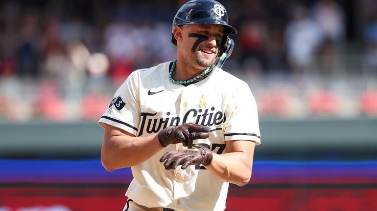 Minnesota Twins' Royce Lewis celebrates his three-run home run as...