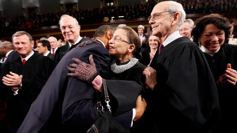 President Barack Obama hugs Supreme Court Justice Ruth Bader Ginsburg...