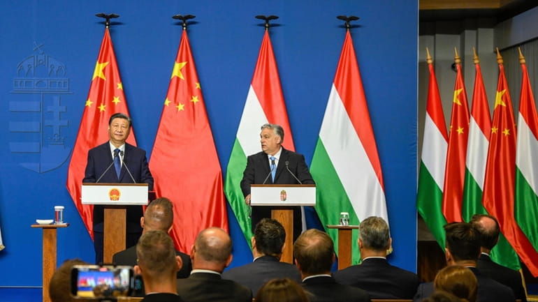 Chinese President Xi Jinping, left, listens during his joint press...