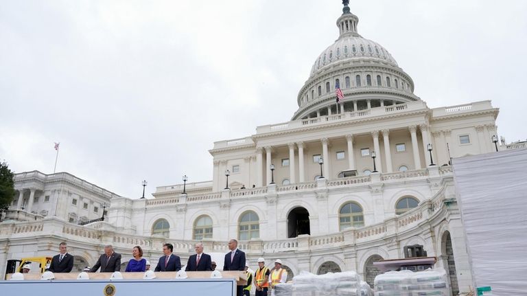 Congress members hammer in the first nails at the First...