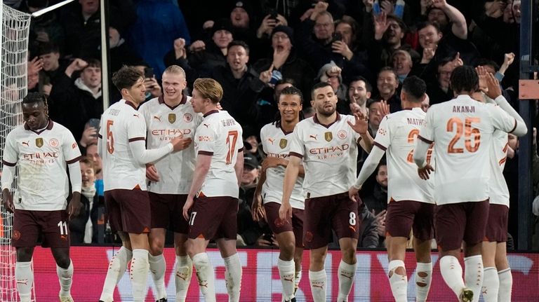 Manchester City's Erling Haaland, third from left, celebrates with his...