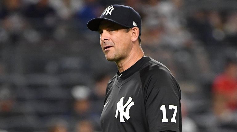 Yankees manager Aaron Boone walks to the dugout during the...