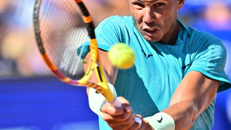 Spain's Rafael Nadal returns the ball to Portugal's Nuno Borges...