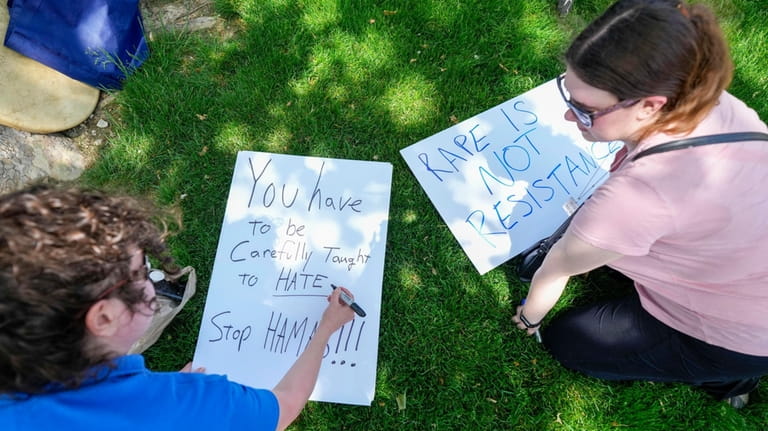 Protestors make signs before a pro-Israel rally at Indiana University...