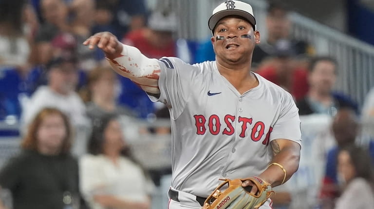 Boston Red Sox third baseman Rafael Devers (11) throws to...
