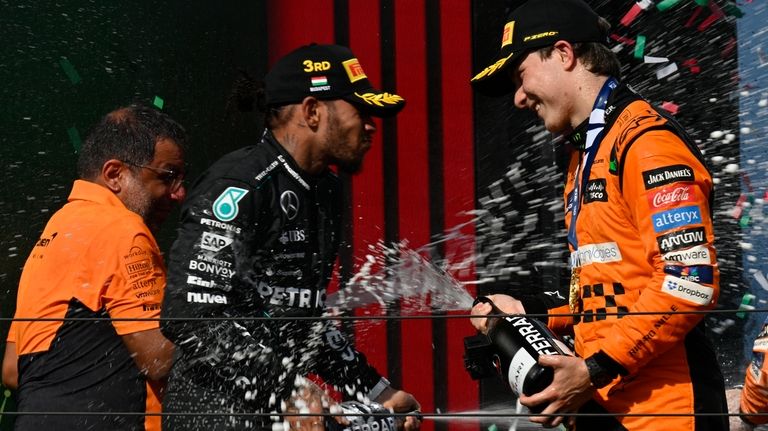 McLaren driver Oscar Piastri of Australia, right, celebrates with third...