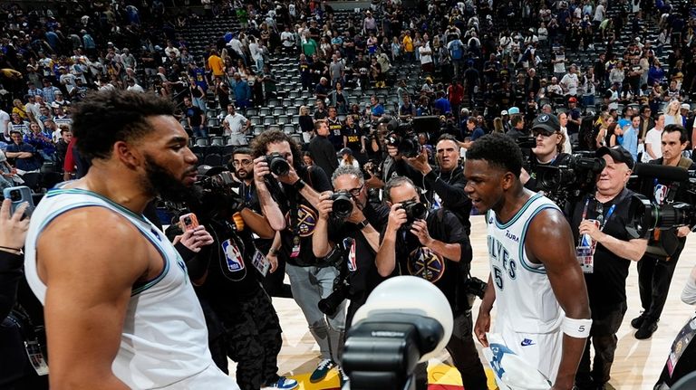 Minnesota Timberwolves center Karl-Anthony Towns, left center, celebrates with guard...