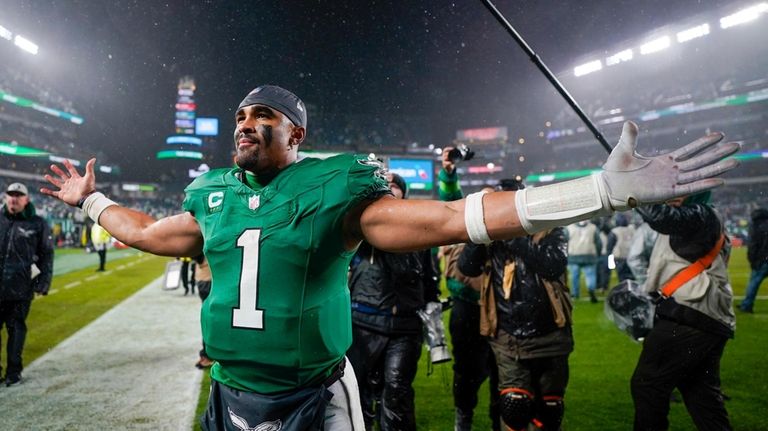 Philadelphia Eagles quarterback Jalen Hurts celebrates after scoring the game...