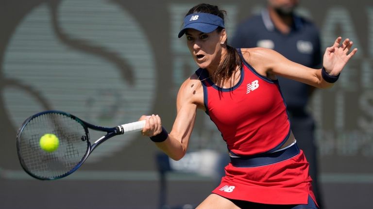 Solana Cirstea of Romania returns the ball to Marketa Vondrousova...