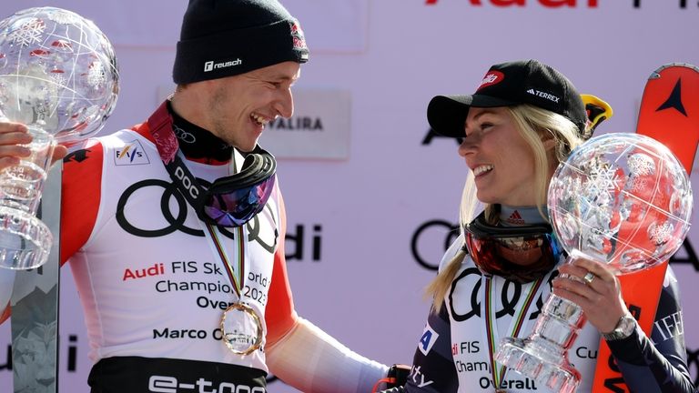 Switzerland's Marco Odermatt, left, and United States' Mikaela Shiffrin celebrate...