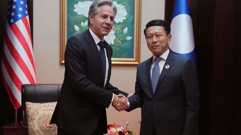 U.S. Secretary of State Antony Blinken, left, shakes hands with...