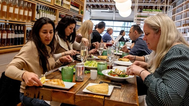 The communal table at Herb & Olive in Manhassett.