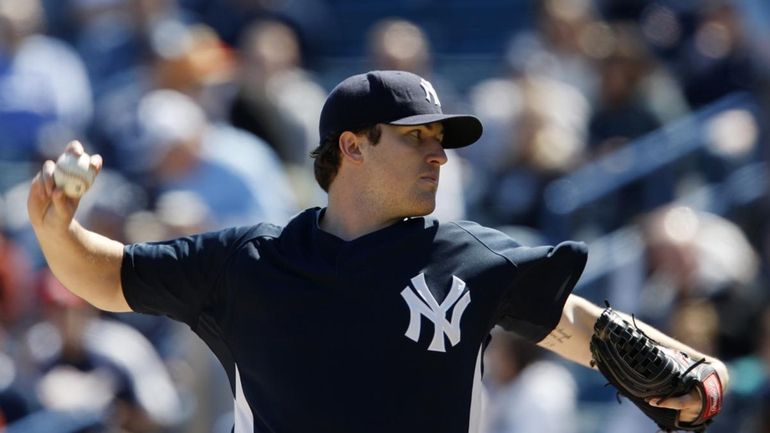 New York Yankees starting pitcher Phil Hughes (65) throws in...