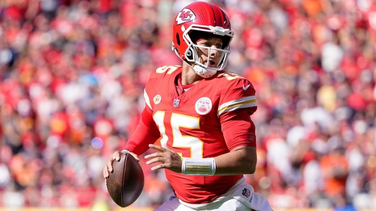 Kansas City quarterback Patrick Mahomes runs with the ball during...