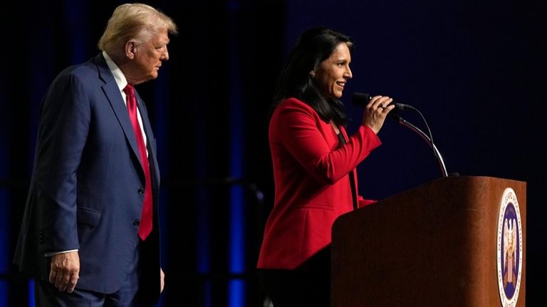 Republican presidential nominee former President Donald Trump, left, looks on...