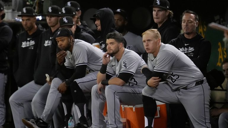 Chicago White Sox players react from the dugout during the...