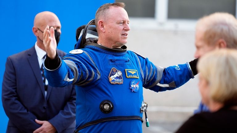 NASA astronaut Butch Wilmore gestures as he talks to family...