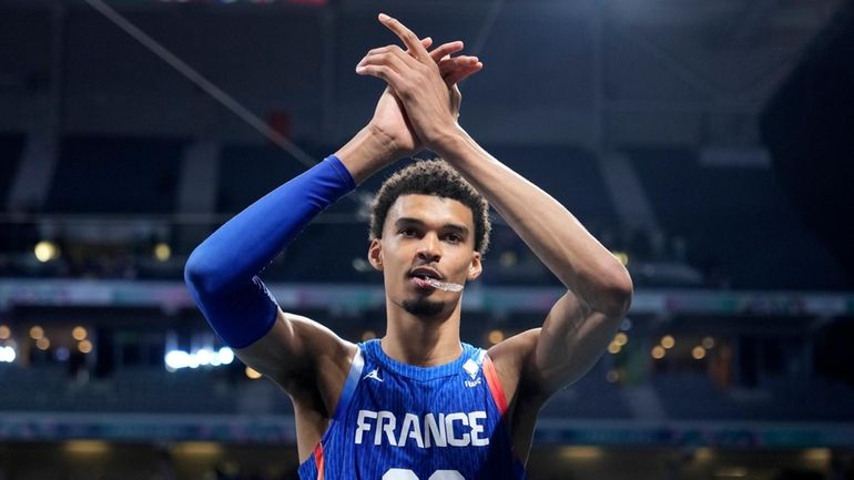 France's Victor Wembanyama claps as he leaves the court after...