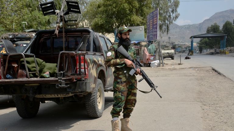 A soldier of Afghan Taliban forces stands guard close to...