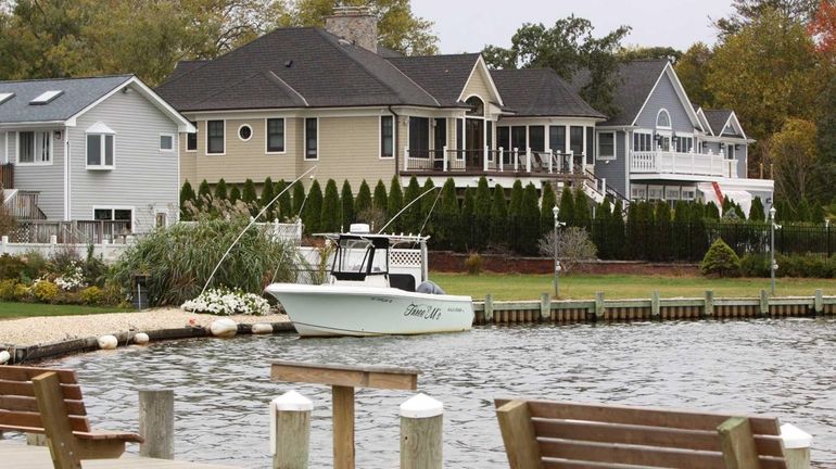 Homes along the Connetquot River in Great River mostly fared...